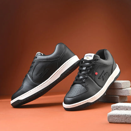 Black sneakers with white soles on a brown background